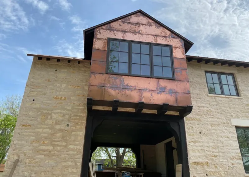Copper metal panel facade on a stone building for Metal Roof Coating in Kennedale